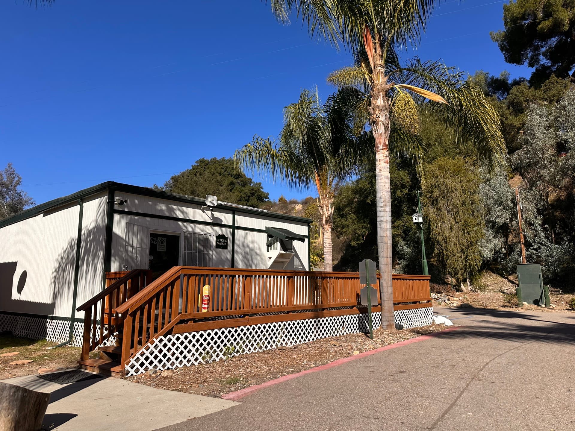 Office and clubhouse with palm tree at Rancho Corrido Park
